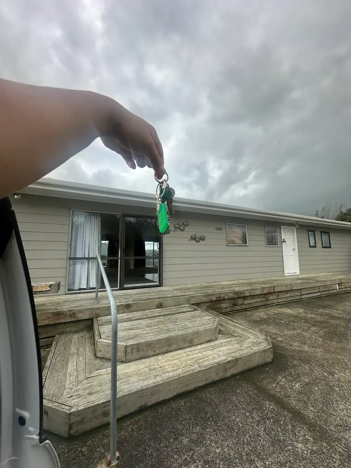 Keys held up in front of a new home
