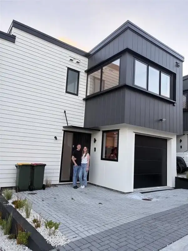 Couple at the front door of their new townhouse