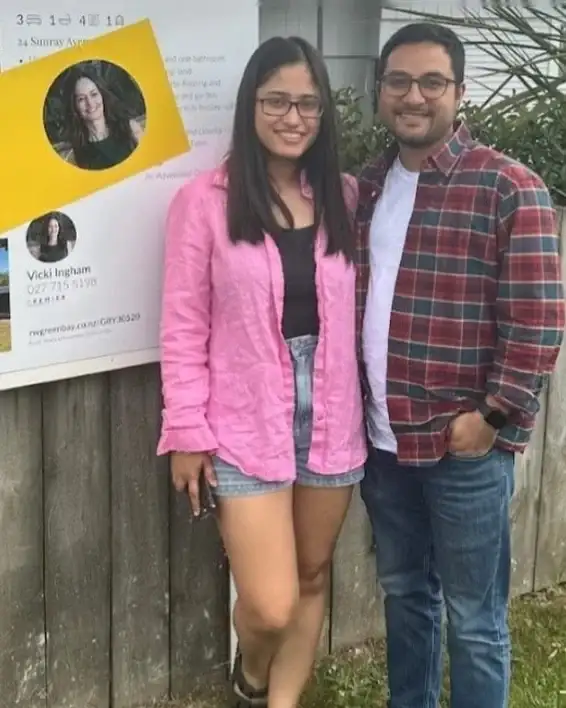 Couple beside their Another Sold sign
